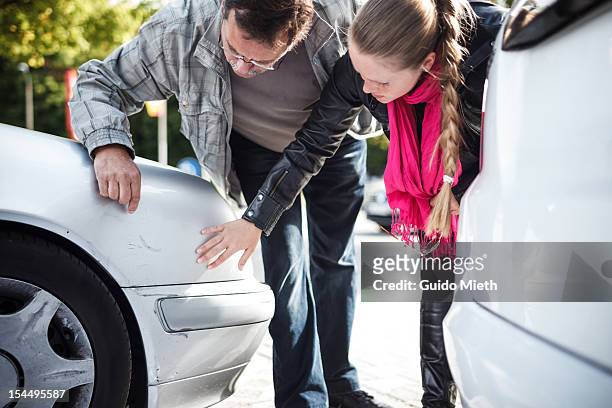 man and woman looking car after accient. - damaged stock pictures, royalty-free photos & images