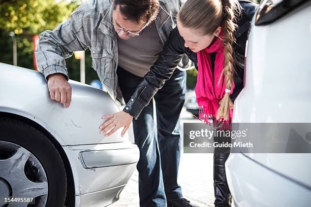 man and woman looking car after accient. - car collision stock pictures, royalty-free photos & images