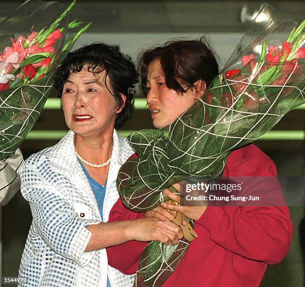 North Korean defector cries with Kim Bhun-Ney , her relative - who escaped from North Korea last June and now lives in Seoul - on her arrival May 23,...