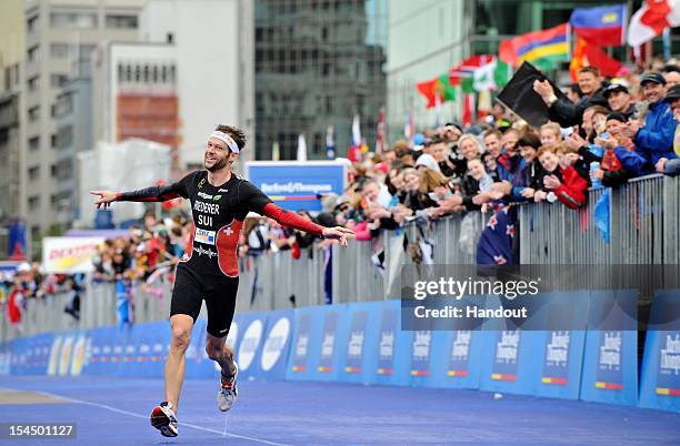 In this handout photo released by the International Triathlon Union, Sven Riederer of Switzerland celebrates finishing in 3rd place and winning a...