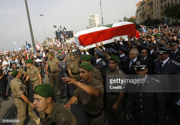 Lebanese officers of Internal Security Forces carry the coffin of assassinated top intelligence chief General Wissam al-Hassan, during his funeral...