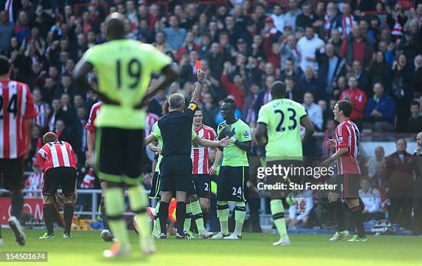 Newcastle player Cheick Tiote is shown the red card by referee Martin Atkinson during the Barclays Premier league match between Sunderland and...