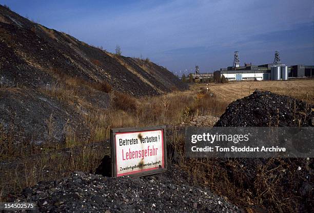 Uranium waste tip at a mine at Beerwalde, East Germany, 1991. The sign reads; 'Betreten verboten! Lebensgefahr' (no trespassing! Danger of death'.