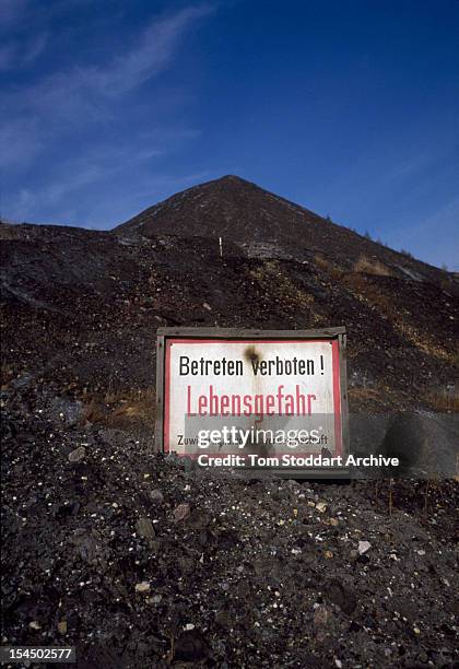 Uranium waste tip at a mine at Beerwalde, East Germany, 1991. The sign reads; 'Betreten verboten! Lebensgefahr' (no trespassing! Danger of death'.