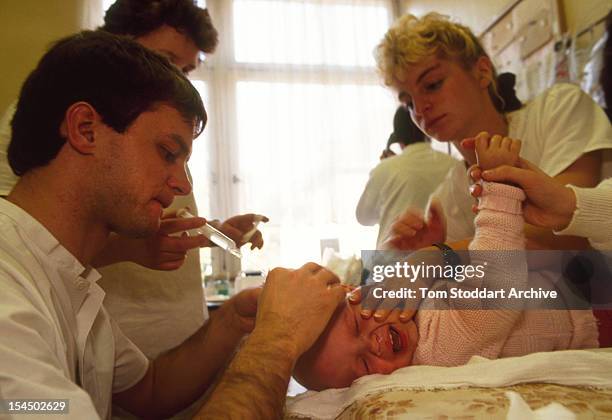 Baby in the cancer ward at Jena hospital in Germany, where high levels of uranium pollute the surrounding area, Jena, East Germany, March 1991.