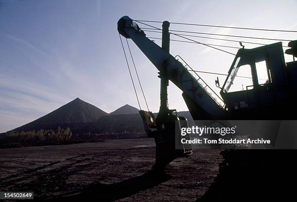 An earth mover at a uranium waste tip near a mine at Beerwalde, East Germany, 1st January 1991.