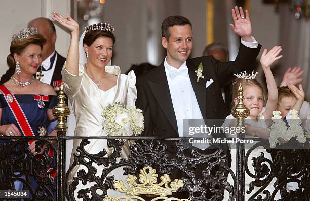Princess Martha Louise of Norway and writer Ari Behn wave from the balcony of the Stiftsgarden Palace after their wedding at the Nidaros Cathedral...