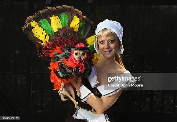 Karen Biehl holds her Chihuahua Eli, who posed as a Thanksgiving turkey at the Tompkins Square Halloween Dog Parade on October 20, 2012 in New York...