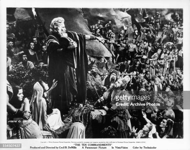 Charlton Heston holds the commandments in the midst of the crowd in a scene from the film 'The Ten Commandments', 1956.