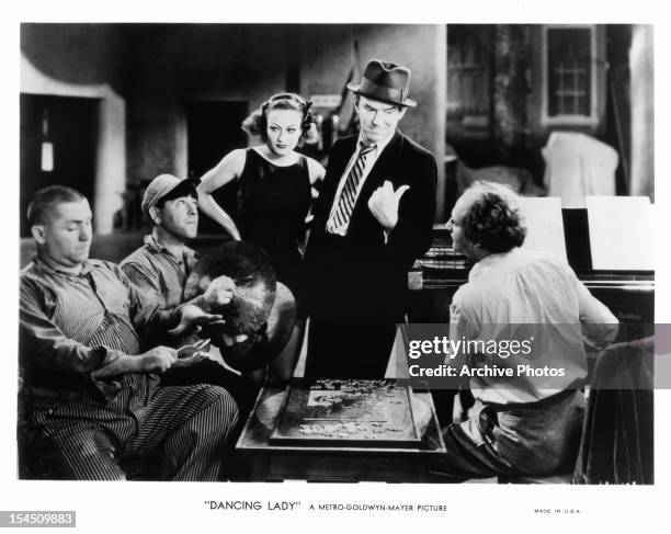 Curly Howard, Moe Howard, Joan Crawford, Ted Healy, and Larry Fine in a scene from the film 'Dancing Lady', 1933.