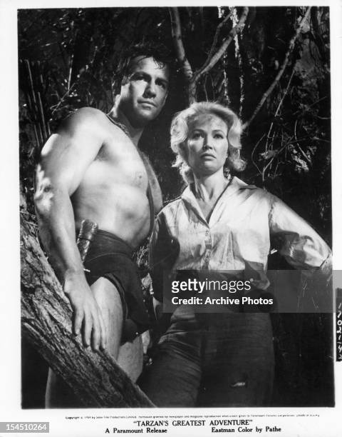 Gordon Scott in a tree with Sara Shane in a scene from the film 'Tarzan's Greatest Adventure', 1959.