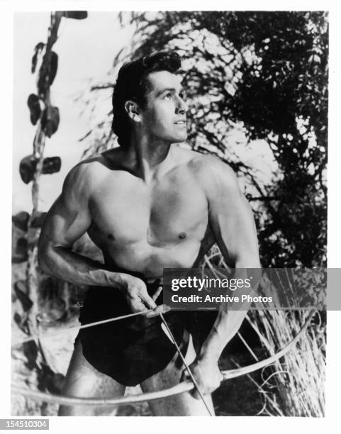 Gordon Scott holds a bow in a scene from the film 'Tarzan's Fight For Life', 1958.