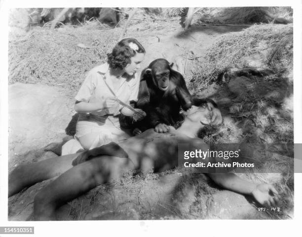 Johnny Weissmuller lays injured while Maureen O'Sullivan takes care of him in a scene from the film 'Tarzan, The Ape Man', 1932.