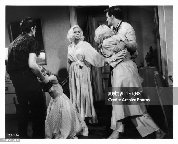 Burt Douglas holds Jan Sterling while Mamie Van Doren watches Diane Jergens being held back by John Drew Barrymore in a scene from the film 'High...