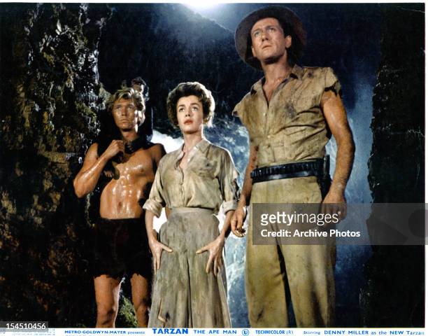 Denny Miller, Joanna Barnes and Robert Douglas explore a cave in a scene from the film 'Tarzan, The Ape Man', 1959.