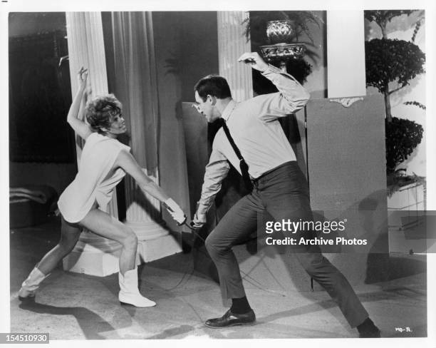 Sue Ane Langdon fences Paul Mantee in a scene from the film 'A Man Called Dagger', 1968.