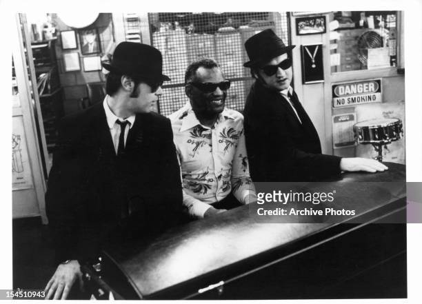 Dan Aykroyd listens as Ray Charles plays piano next to John Belushi in a scene from the film 'The Blues Brothers', 1980.