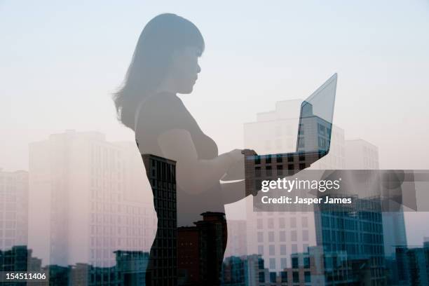 double exposure of woman using laptop and city - double exposure business stock pictures, royalty-free photos & images