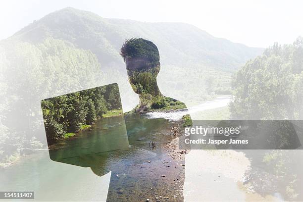 double exposure of man using laptop and nature - double exposure technology stock-fotos und bilder