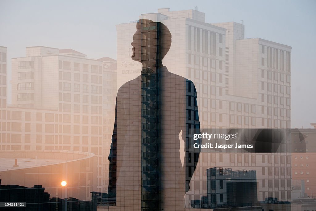 Double exposure of man and buildings