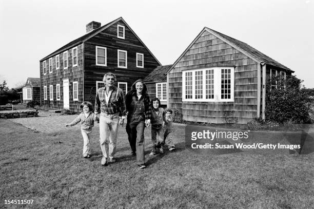 American fashion designer Ralph Lauren and his wife, therapist Ricky Lauren, walk outside their home, with their children, David, Andrew, & Dylan,...