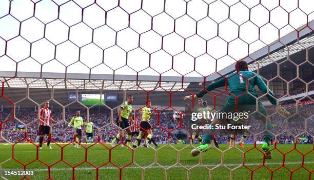 Newcastle player Demba Ba deflects the ball for Sunderlands equaliser from a John O' Shea header during the Barclays Premier league match between...