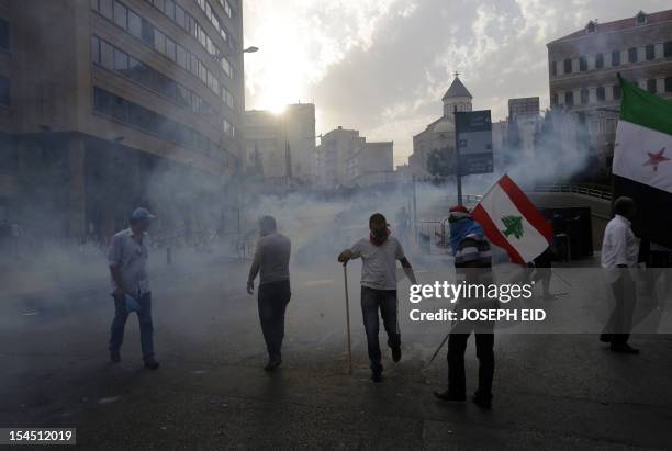 Supportors of the March 14 movement, which opposes the Syrian regime of President Bashar al-Assad, wave their national flag and the Syrian pre-Baath...