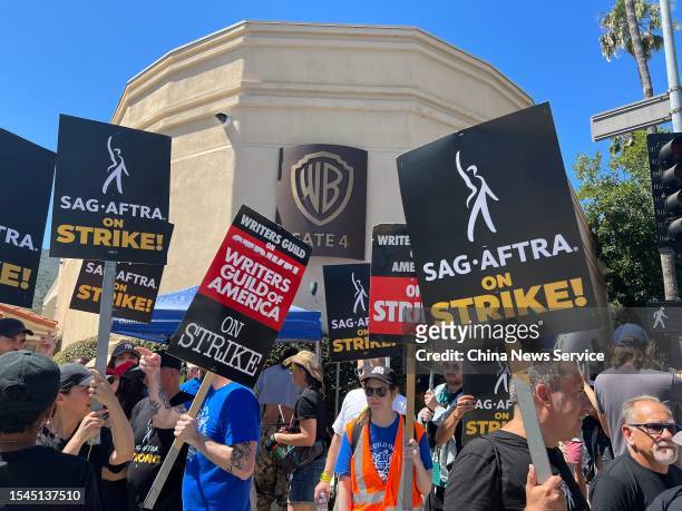 Hollywood writers and their supporters from the SAG AFTRA actors' union go on strike on July 14, 2023 in Los Angeles, California.