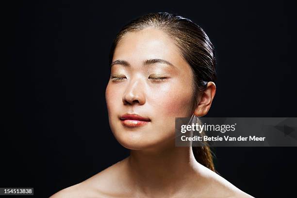 portrait of asian woman with eyes closed. - portrait black background stock pictures, royalty-free photos & images