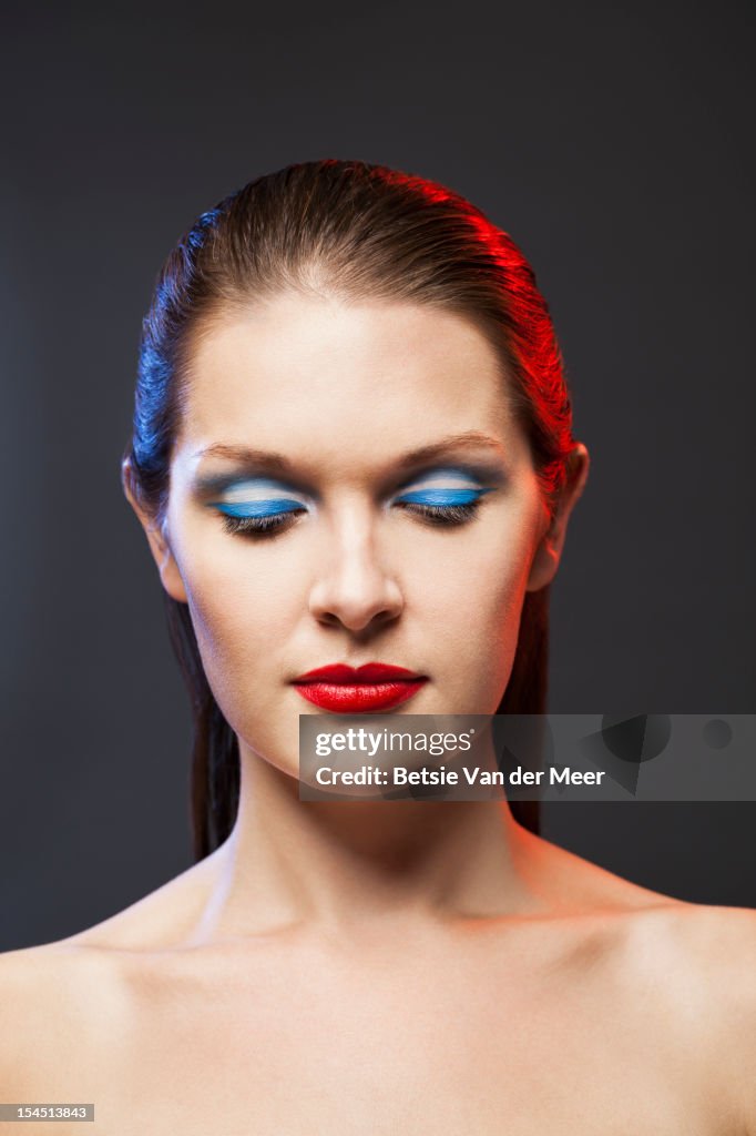 Woman with colour of flag painted on eyes and lips