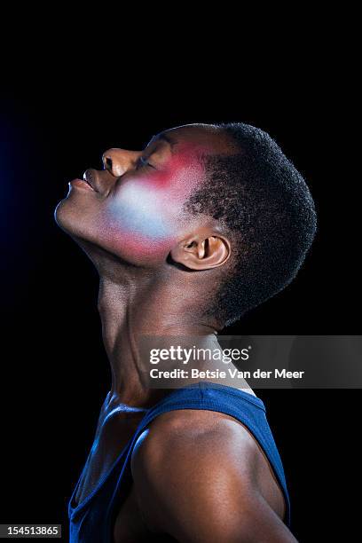 black man with cheek covered in different colours. - man make up stock pictures, royalty-free photos & images