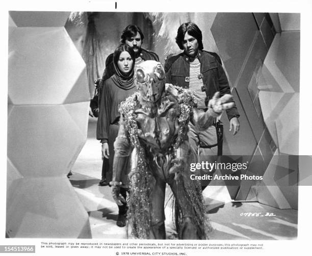 Jane Seymour, Tony Swartz and Richard Hatch follow an alien in a scene from the television series 'Battlestar Galactica', 1978.