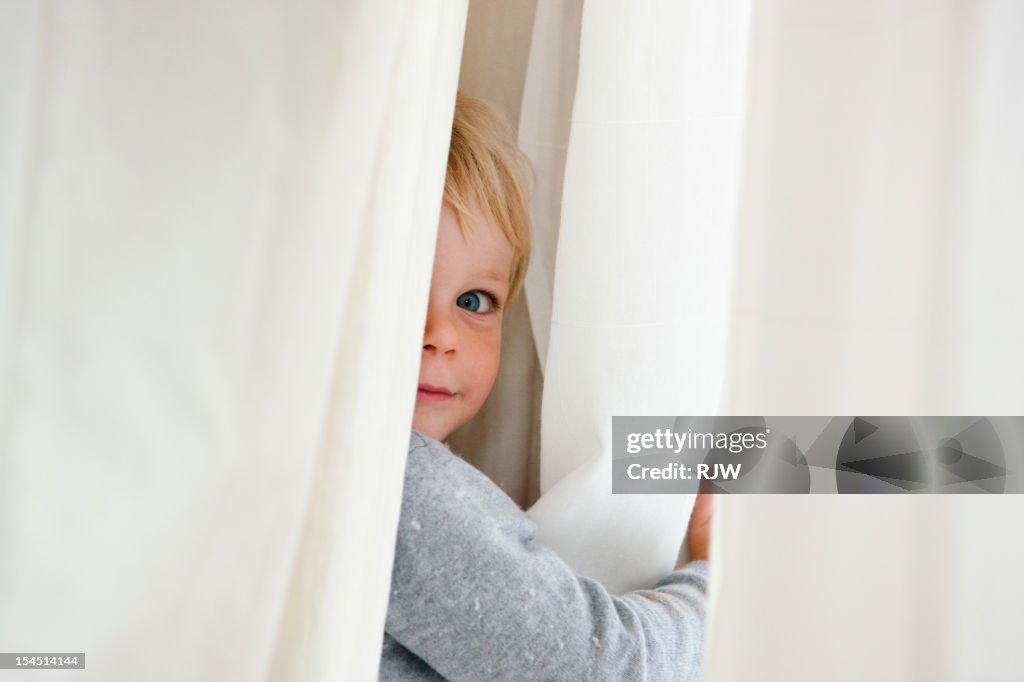 Child Hiding in Curtain