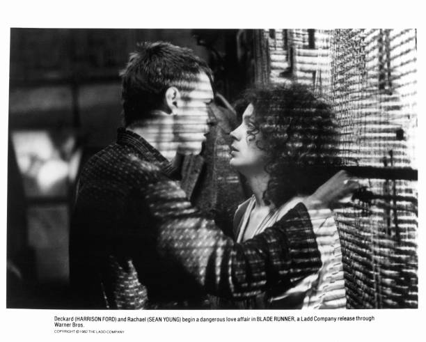 Harrison Ford prepares to kiss Sean Young in a scene from the film 'Blade Runner', 1982.