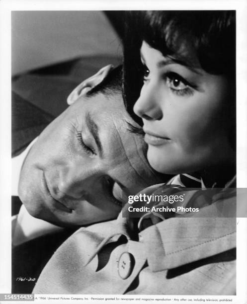 Rock Hudson rests his head on the shoulder of Claudia Cardinale in a scene from the film 'Blindfold', 1965.