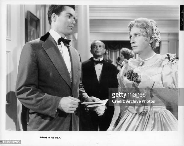 Richard Beymer looking suspiciously at dressed in drag Bing Crosby in a scene from the film 'High Time', 1960.