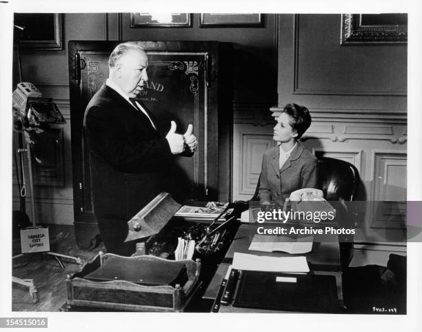 Alfred Hitchcock gives Tippi Hedren directions in between scenes from the film 'Marnie', 1964.