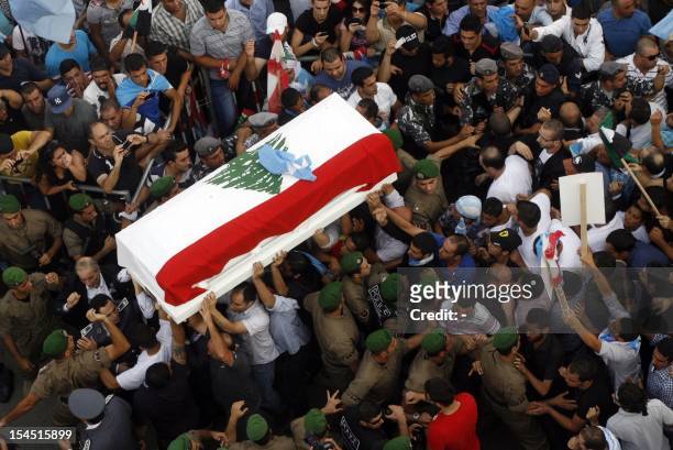 The coffin of assassinated top intelligence chief General Wissam al-Hassan, arrives in downtown Beirut during his funeral procession on October 21,...