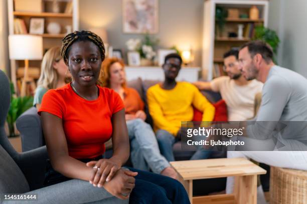 portrait of a woman at group therapy - employee welfare stockfoto's en -beelden