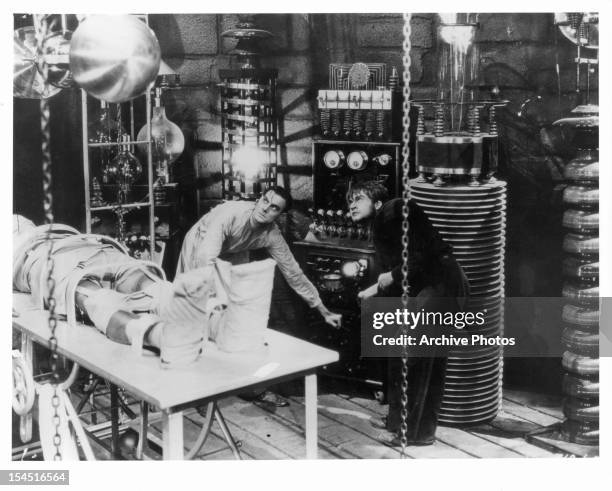 Colin Clive and Dwight Frye in laboratory with monster in a scene from the film 'Frankenstein', 1931.