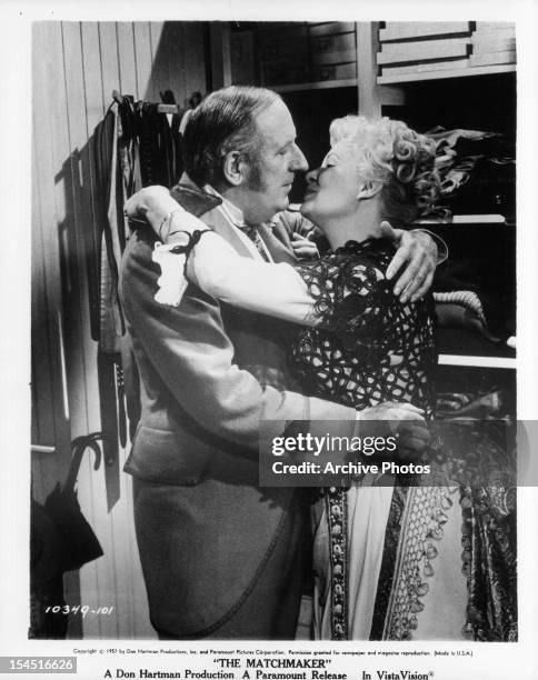 Paul Ford prepares to kiss Shirley Booth in a scene from the film 'The Matchmaker', 1958.