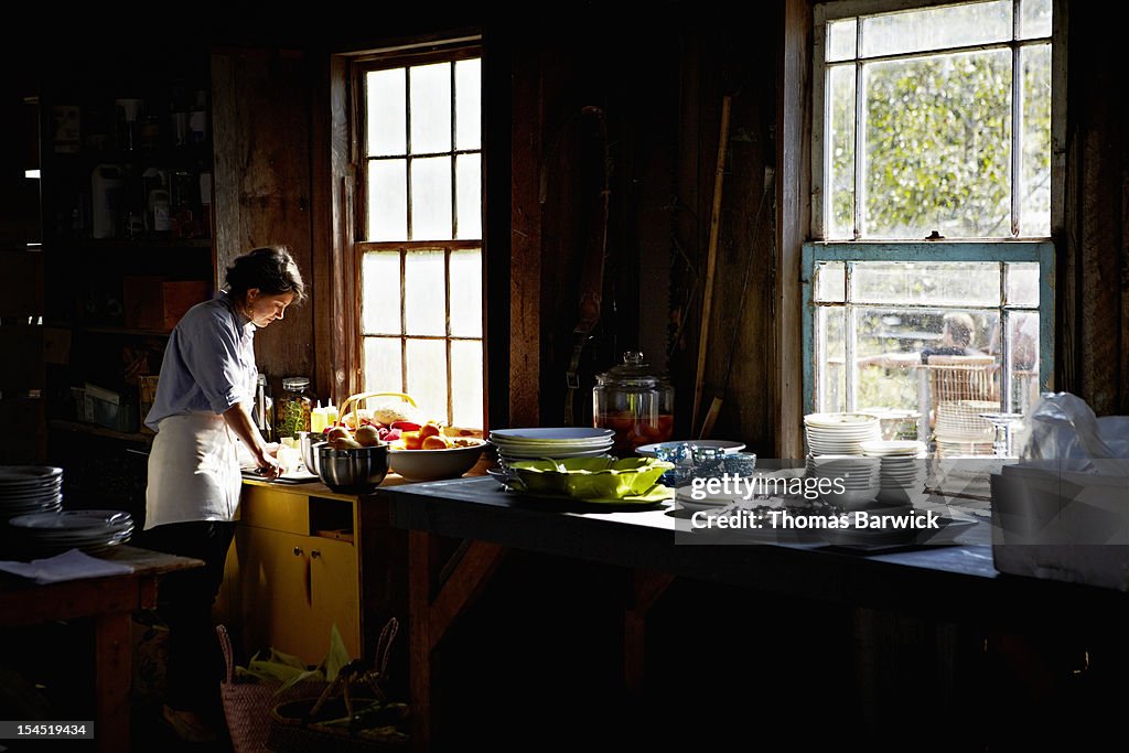 Woman preparing for party in vacation home kitchen