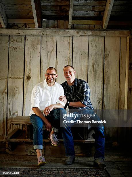 Gay couple seated together laughing