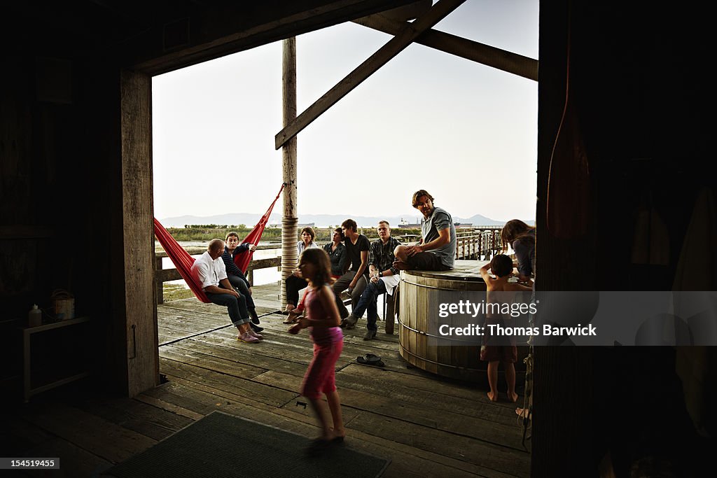 Group of family and friends sitting out on dock