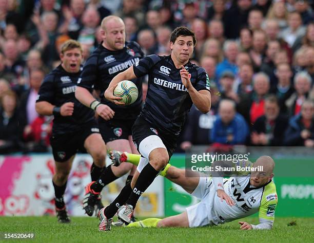 Ben Youngs of Leicester Tigers breaks through the tackle of Richard Fussell of Ospreys during the Heineken Cup Round 2 match between Leicester Tigers...