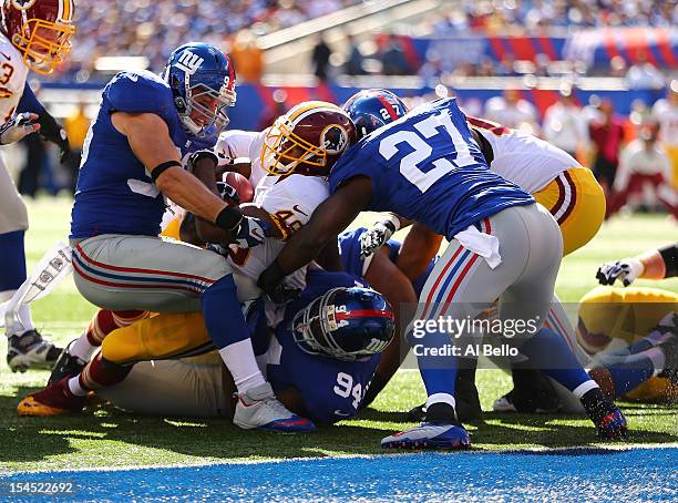 Alfred Morris of the Washington Redskins is stopped short of the goal line against Mathias Kiwanuka, Stevie Brown, and Chase Blackburn of the New...