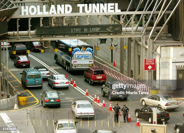 Port Authority of New York and New Jersey police officers, who did not want to be identified, stand guard at the Manhattan entrance to the Holland...