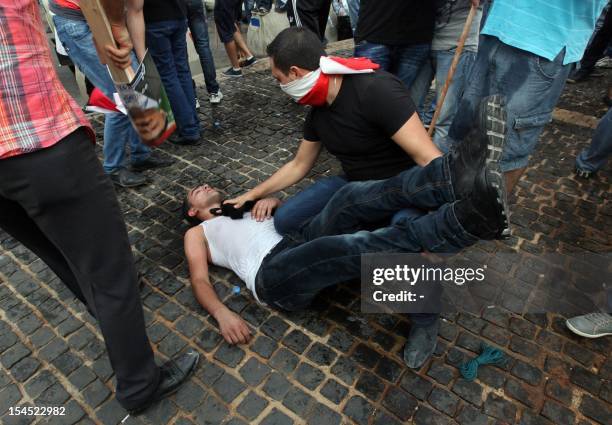 Supporter of the March 14 movement, which opposes the Syrian regime of President Bashar al-Assad, recovers from the inhalation of tear gas, which was...