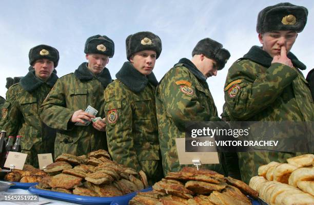 Belarussian special interior troops buy patties during a winter send-off holiday in Minsk, 25 February 2007. AFP PHOTO / VIKTOR DRACHEV