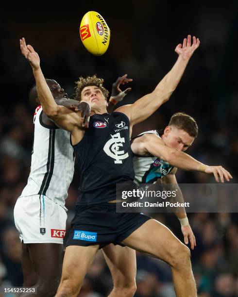 Charlie Curnow of the Blues marks the ball against Aliir Aliir of the Power during the round 18 AFL match between Carlton Blues and Port Adelaide...